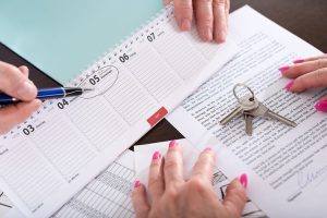 Real estate agent showing the effective date of lease on calendar (random english dummy text used)