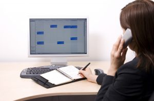 Beautiful girl on telephone in office.